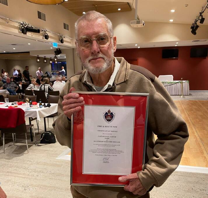 Paul Carter with his NSW Fire & Rescue certificicate of service after retiring in 2021. Picture Fire & Rescue Lithgow West
