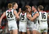 Port Adelaide's Jason Horne-Francis (C) celebrates with teammates after kicking a goal. Photo: James Ross/AAP PHOTOS