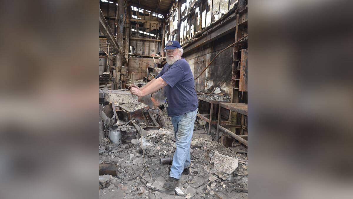 TOUGH TIMES: Zig Zag Railway’s CEO Michael Forbes in the ruins of the machine workshop that had the office collapse on it lm110413zigzag4