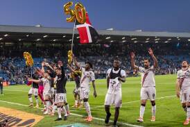 Leverkusen's players celebrate 50 undefeated matches in a row after the win at Bochum. (AP PHOTO)